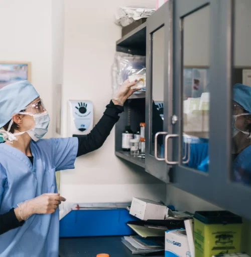 doctor-reaches-towards-shelf